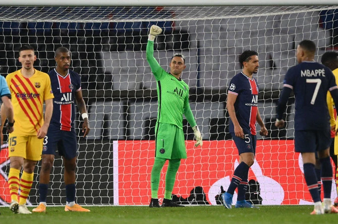 PSG’s goalkeeper Kaylor Navas celebrates after saving a penalty kick during their UEFA Champions League match against FC Barcelona in Paris, in March 2021. (AFP/File)