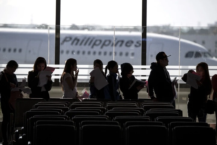 Philippine workers returning home from Kuwait arrive at Manila International Airport on Feb. 18, 2018, following a worker deployment ban to the Gulf country due to a murder case. (AFP)
