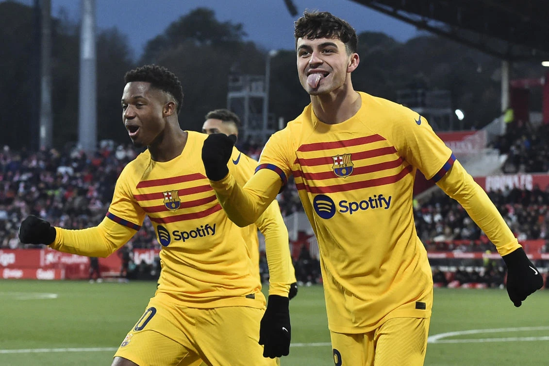 Barcelona’s Spanish midfielder Pedri celebrates scoring the opening goal next to teammate Ansu Fati during their Spanish League match against Girona FC at the Montilivi stadium in Girona on Jan. 28, 2023. (AFP)