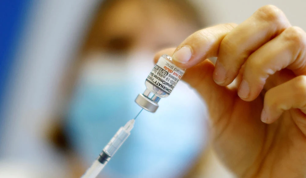 A medical worker prepares a dose of the "Cominarty" Pfizer-Bivalent coronavirus disease (COVID-19) vaccine. (REUTERS)