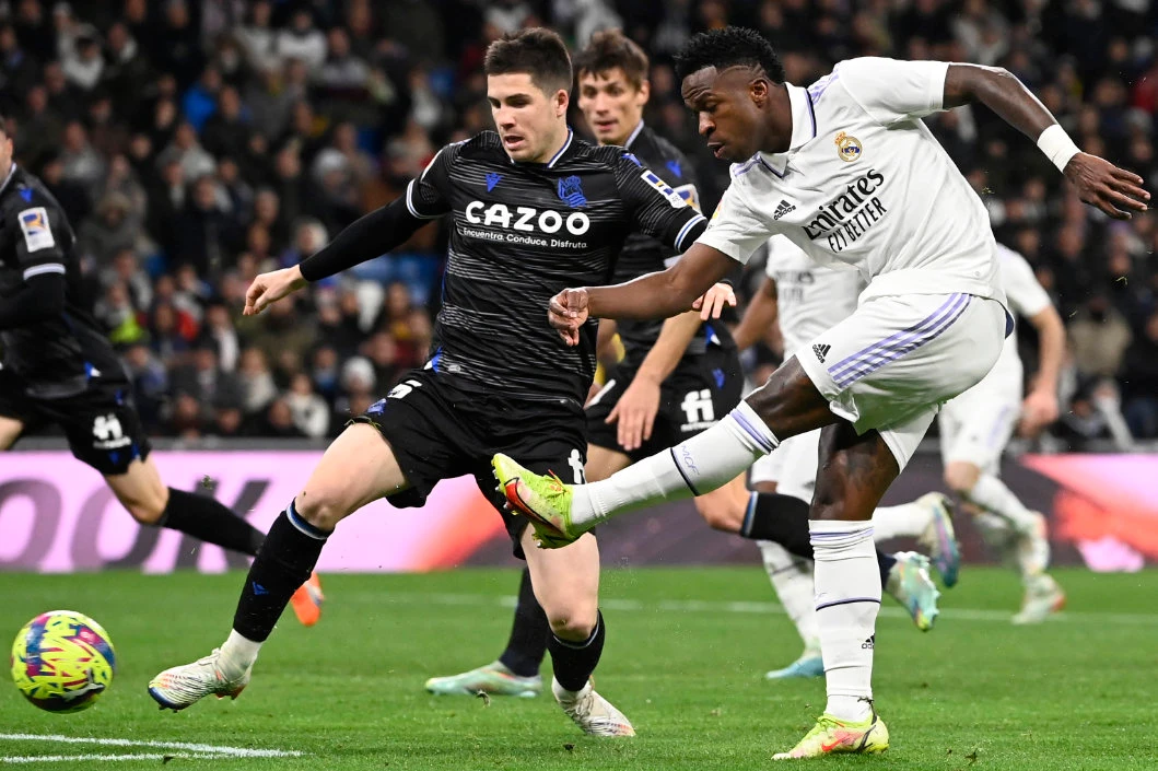 Real Madrid’s Brazilian forward Vinicius Junior (R) shoots the ball next to Real Sociedad’s Spanish midfielder Igor Zubeldia during the Spanish league football match between Real Madrid CF and Real Sociedad at the Santiago Bernabeu stadium in Madrid on January 29, 2023. (AFP)