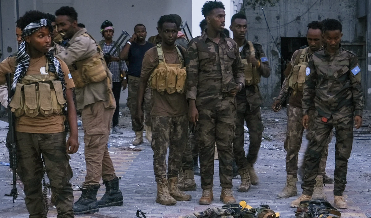 Police officers stand near the bodies of alleged Al-Shabaab militants who have been killed after the siege at the Mogadishu Municipality Headquaters in Mogadishu on January 22, 2023. (AFP/File)