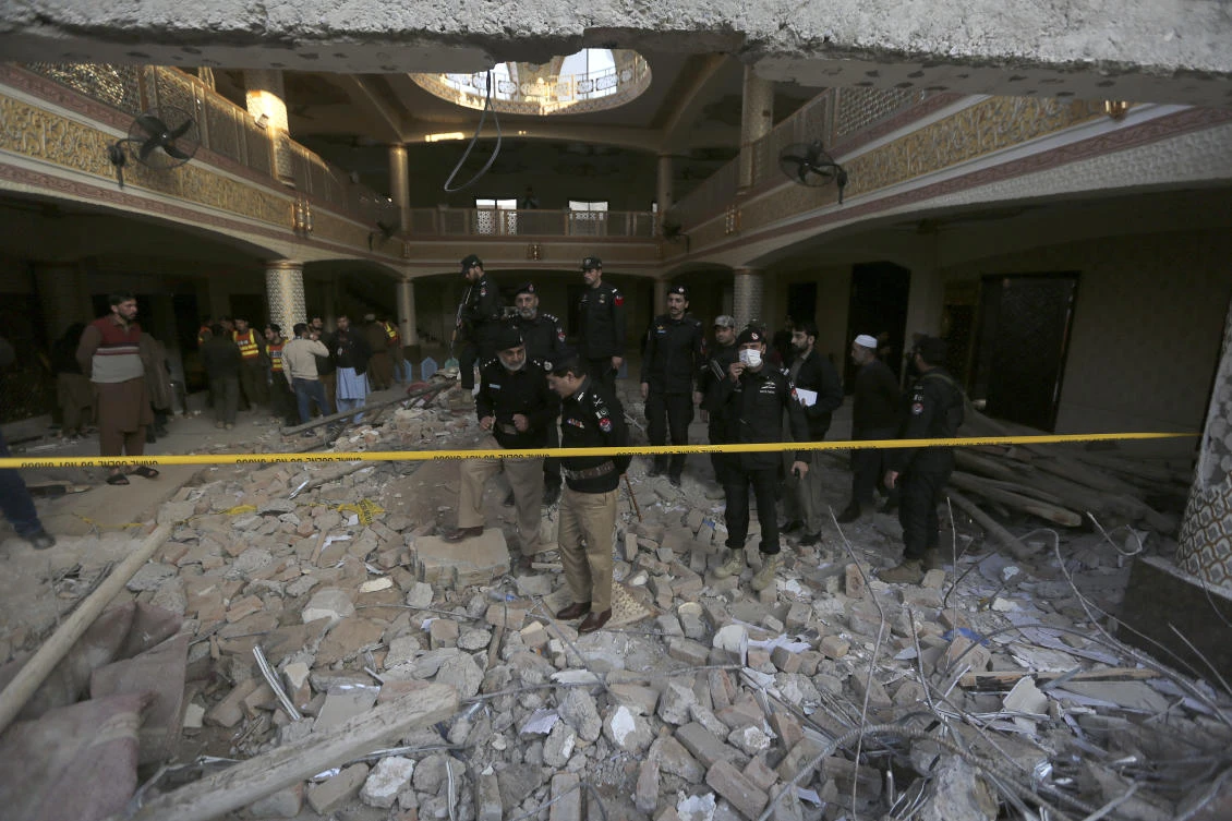 Police officers examine the site of Monday’s suicide bombing after authorities finished the rescue operation, in Peshawar on Jan. 31, 2023. (AP)