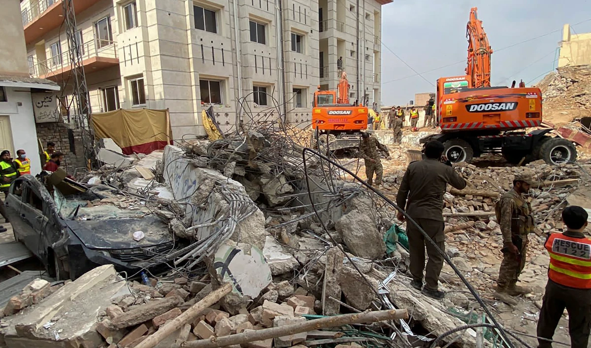 Authorities use heavy machinery to clear the rubble and search for victims a day after a suicide blast at a mosque inside the police headquarters in Peshawar on January 31, 2023. (AFP)
