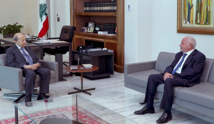 Lebanese Judge Ghassan Ouweidat (R) meeting with President Michel Aoun at the presidential palace of Baabda on July 30, 2021.