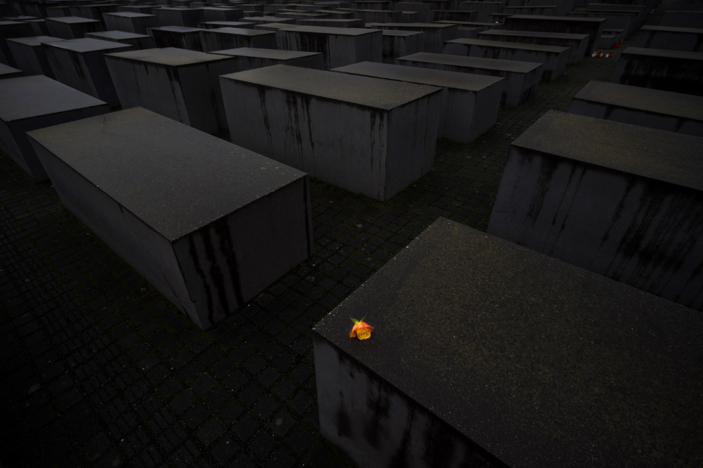 A rose has been placed on a memorial stele at The Memorial to the Murdered Jews of Europe in Berlin, Germany. (AFP)
