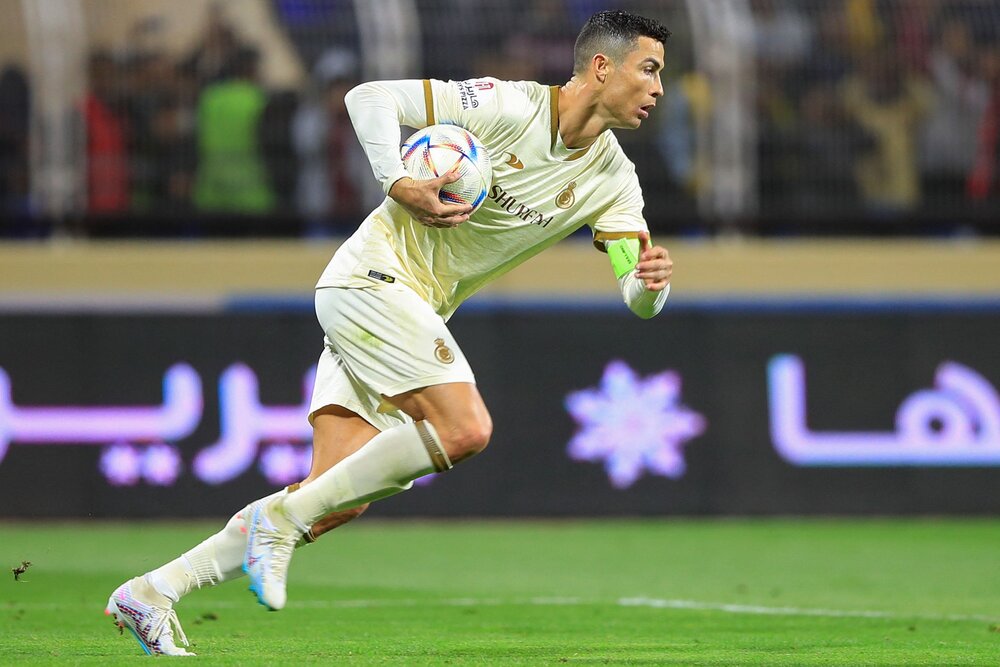 Al-Nassr's Portuguese forward Cristiano Ronaldo runs with the ball after scoring a penalty during their Saudi Pro League match against Al-Fateh at the Prince Abdullah bin Jalawi Stadium in al-Hasa on Feb. 3, 2023. (AFP)