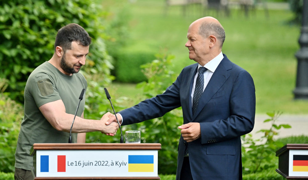 Ukrainian President Volodymyr Zelensky and Chancellor of Germany Olaf Scholz shake hands after a press conference following their meeting in Mariinsky Palace, in Kyiv, on June 16, 2022. (AFP)