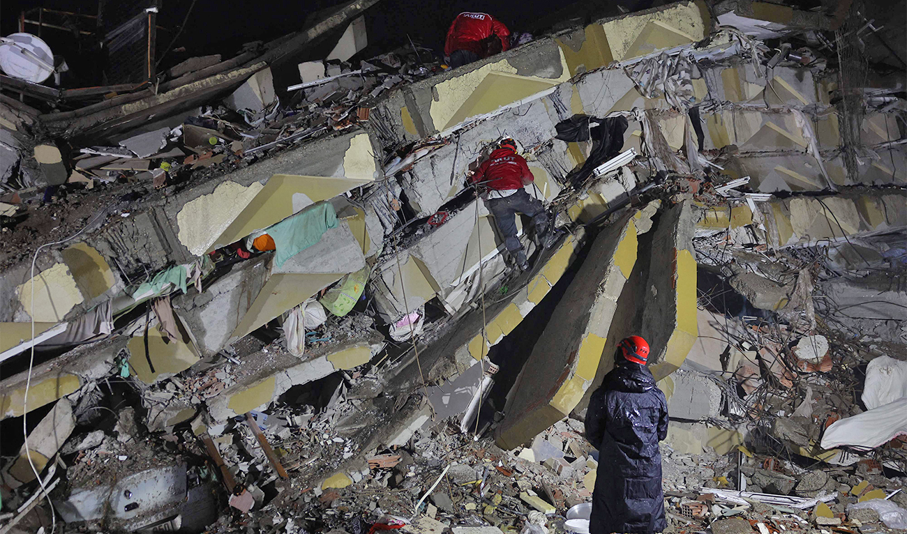 Rescuers search for victims and survivors amidst the rubble of collapsed buildings in Kahramanmaras, Turkey, after a 7.8-magnitude earthquake struck the country's southeast on February 7, 2023. (AFP)