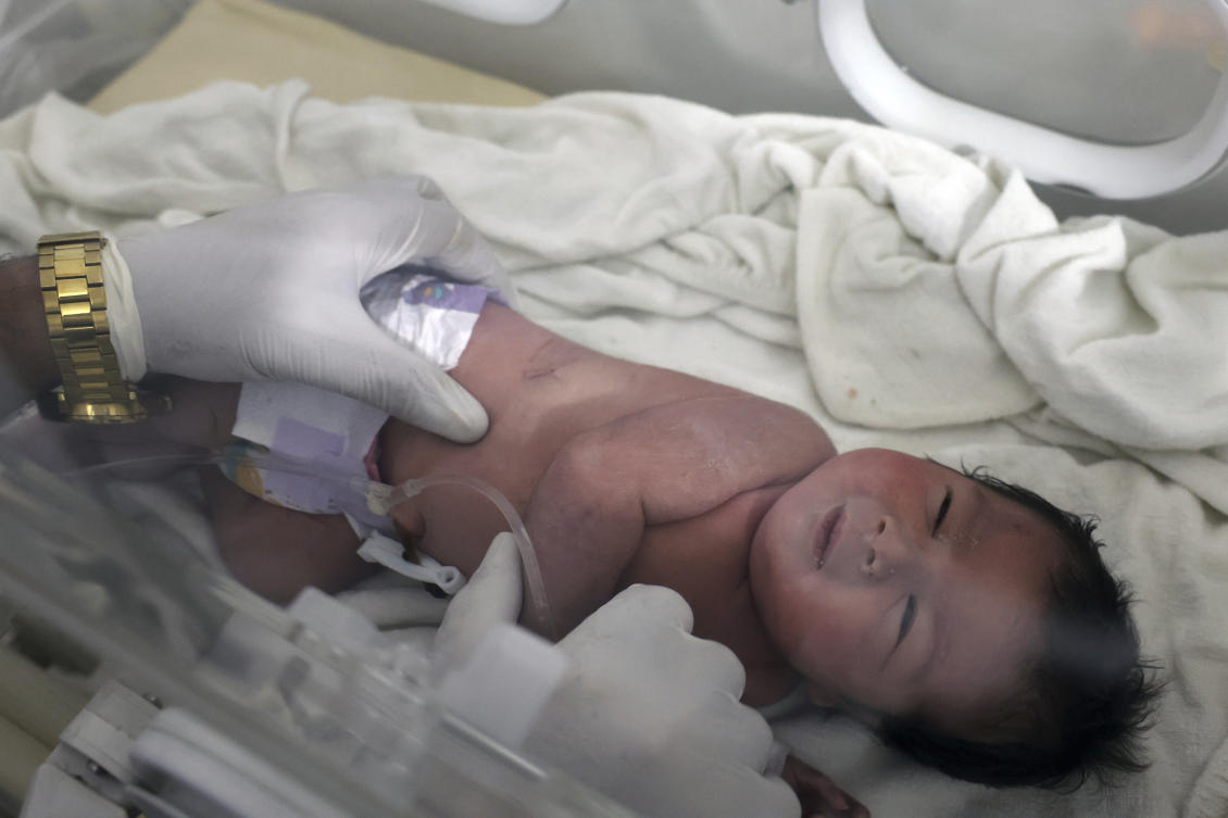 A baby girl who was born under the rubble caused by an earthquake that hit Syria and Turkey receives treatment inside an incubator at a children's hospital in the town of Afrin, Aleppo province, Syria, Tuesday, Feb. 7, 2023. (AP)