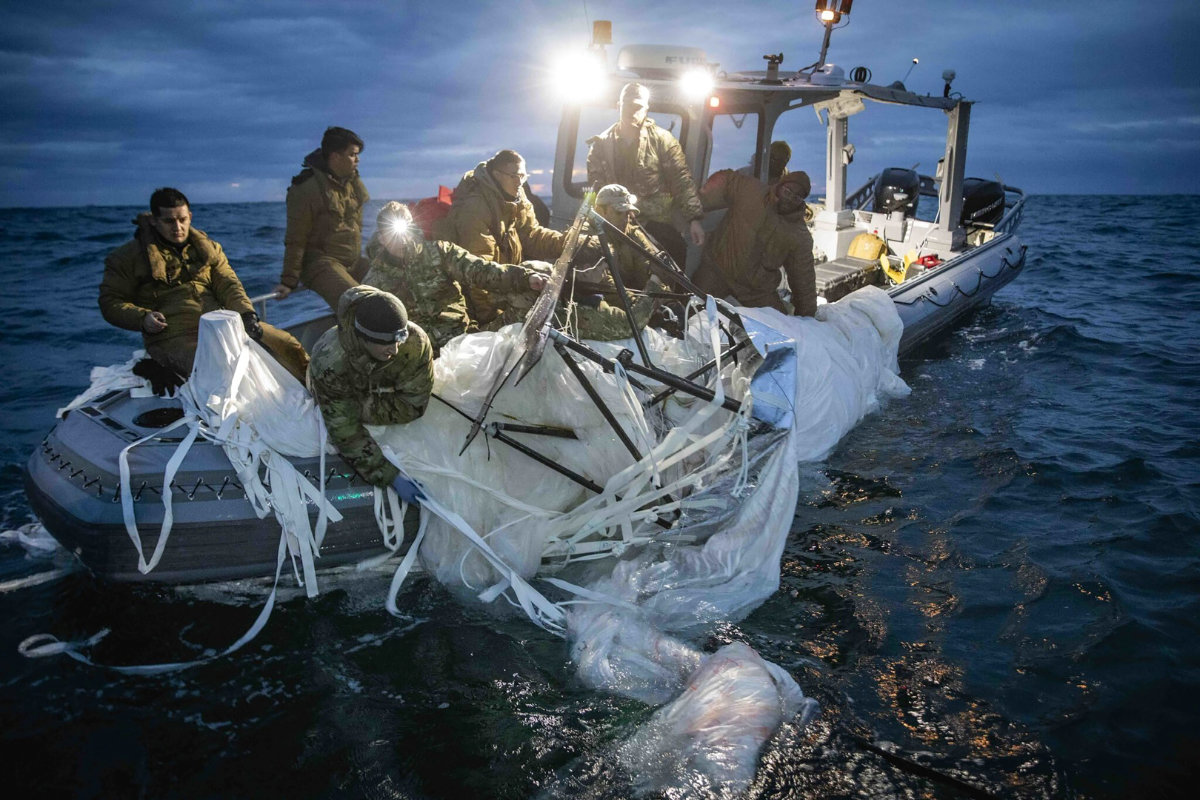 US Navy sailors recovering a high-altitude surveillance balloon off the coast of Myrtle Beach, South Carolina on Feb. 5, 2023, after it was shot down by an air force jet fighter. (US Navy via AP)