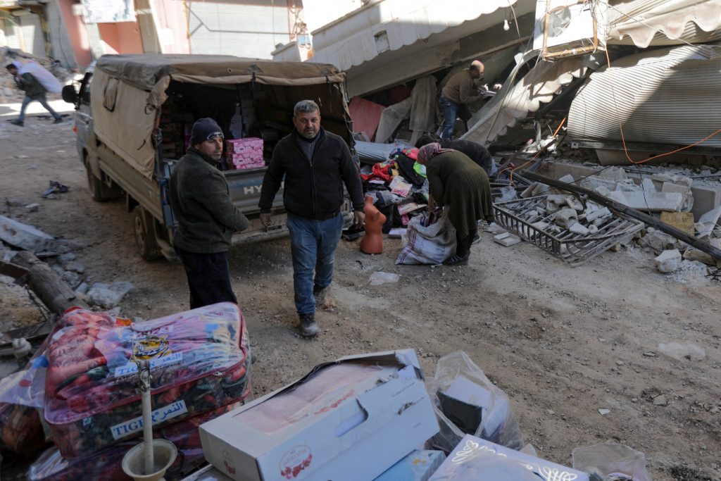 People try to salvage what remains of their shop before leaving the town of Jandaris , in Syria’s rebel-held part of Aleppo province. (AFP)
