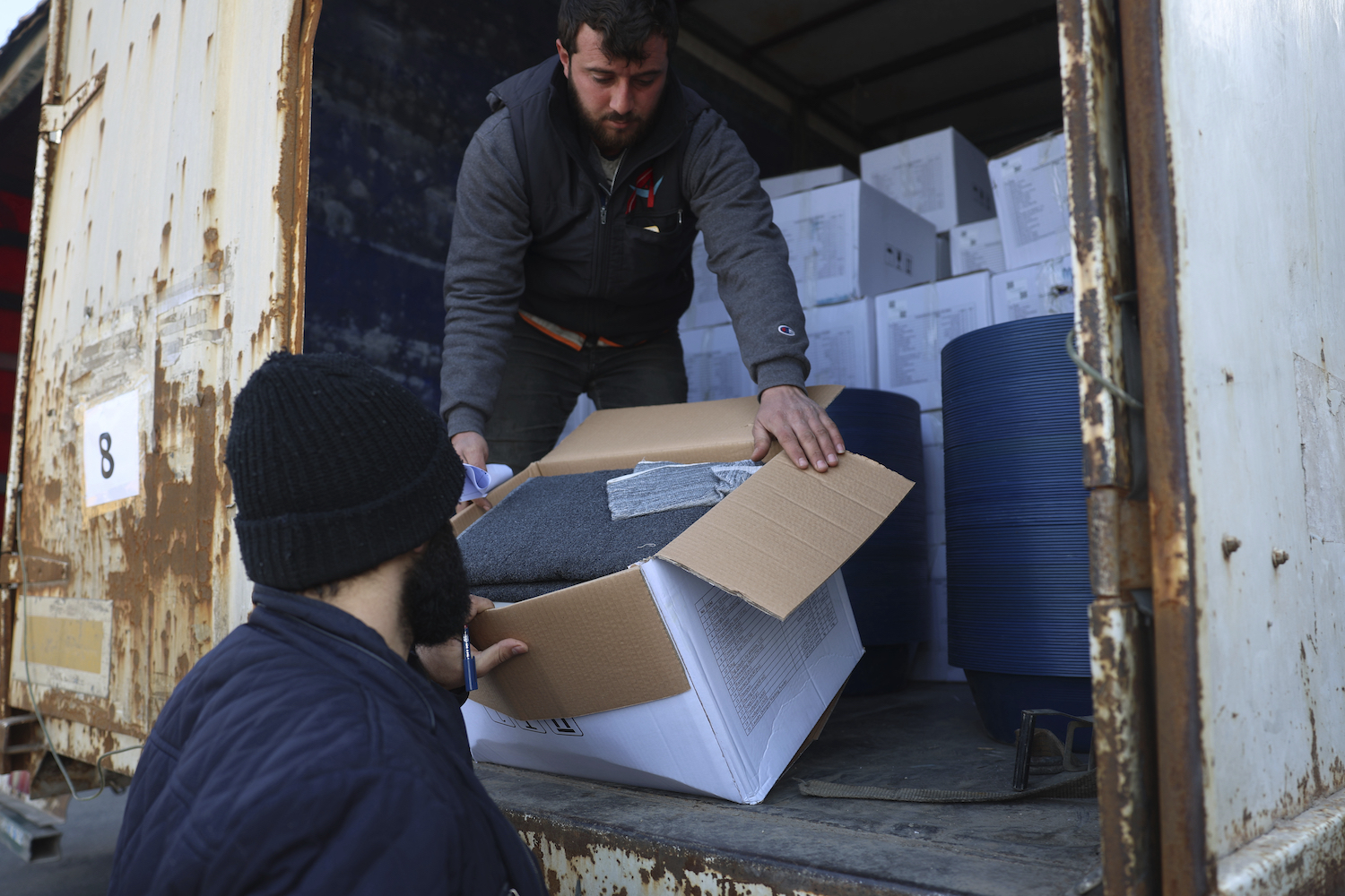 Border customs officials inspect a truck loaded with UN humanitarian aid for Syria at the Bab Al-Hawa border crossing with Turkey, Idlib province, Syria. (File/AFP)