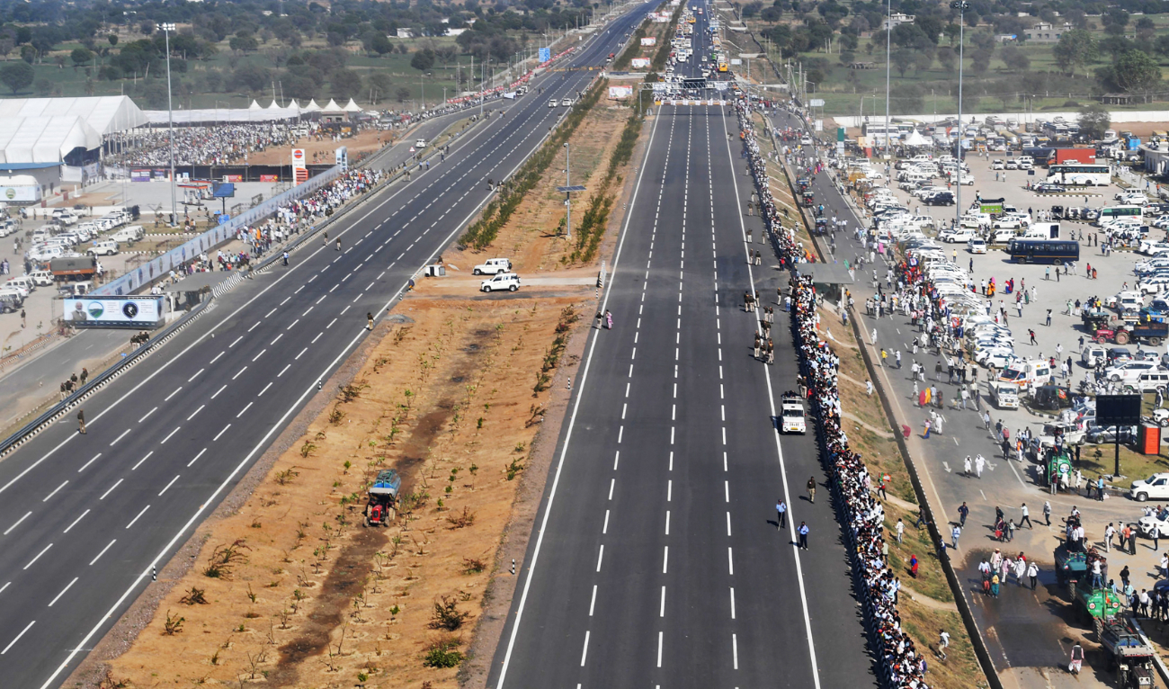 People standing along the newly inaugurated Delhi-Dausa-Lalsot section of the Delhi-Mumbai Expressway in Dausa, in India's desert state of Rajasthan. (AFP)