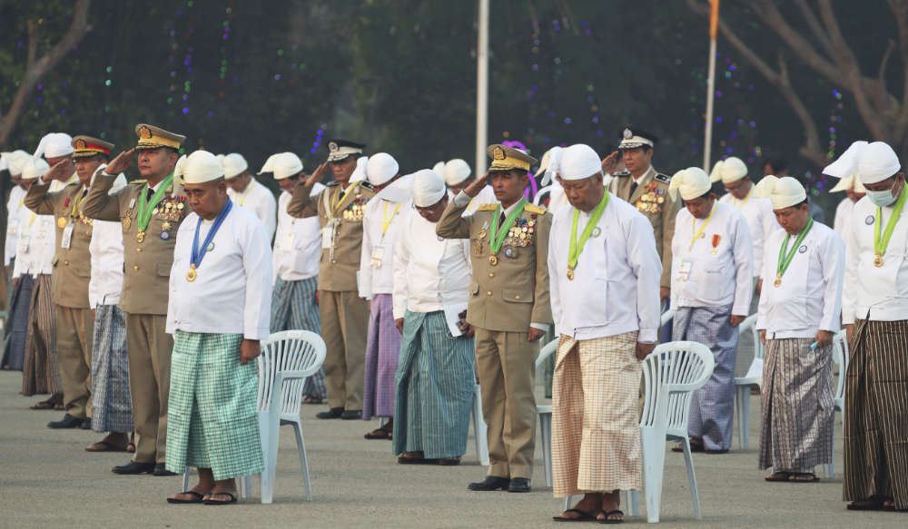 Myanmar government officials salute at their national flag during a ceremony to mark Myanmar's 76th anniversary of Union Day in Naypyitaw, Myanmar, Sunday, Feb. 12, 2023. (AP)