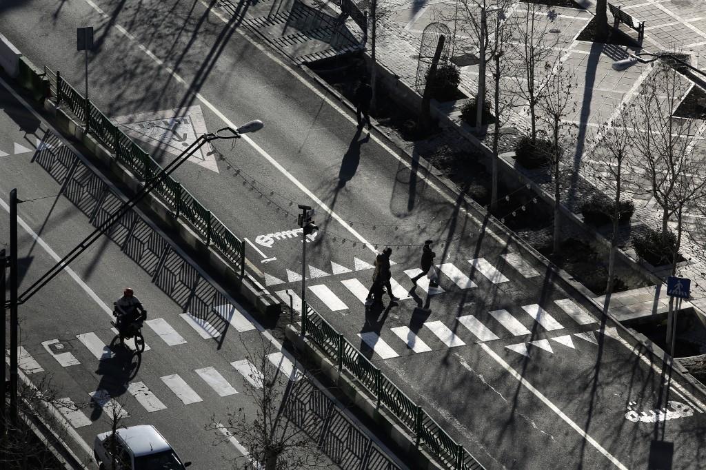 Iranians walk in a street in the capital Tehran on Jan. 7, 2023. (AFP)