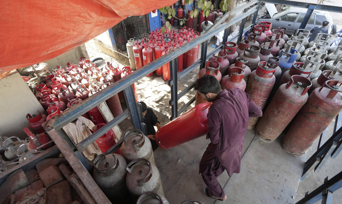 Workers arrange cylinders at a gas filling shop, in Karachi, Pakistan, in Karachi, Pakistan, Tuesday, Feb. 14, 2023. (AP)