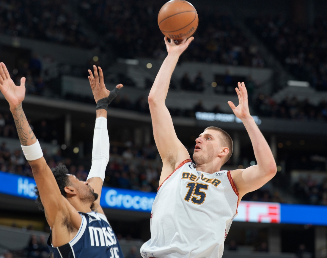 Denver Nuggets center Nikola Jokic, right, goes up for a basket over Dallas Mavericks forward Christian Wood in the second half of an NBA basketball game Wednesday in Denver. (AP)