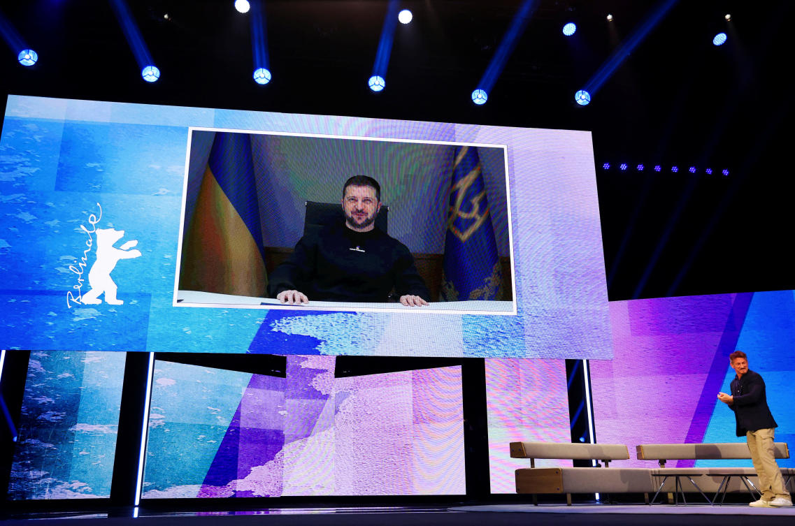 Sean Penn stands on stage as Volodymyr Zelensky addresses the audience on a TV screen during the opening gala of the 73rd Berlinale International Film Festival, Berlin, Germany, Feb. 16, 2023. (Reuters)