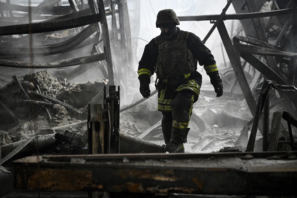 A Ukrainian firefighter walks amid rubble. (AFP/File)