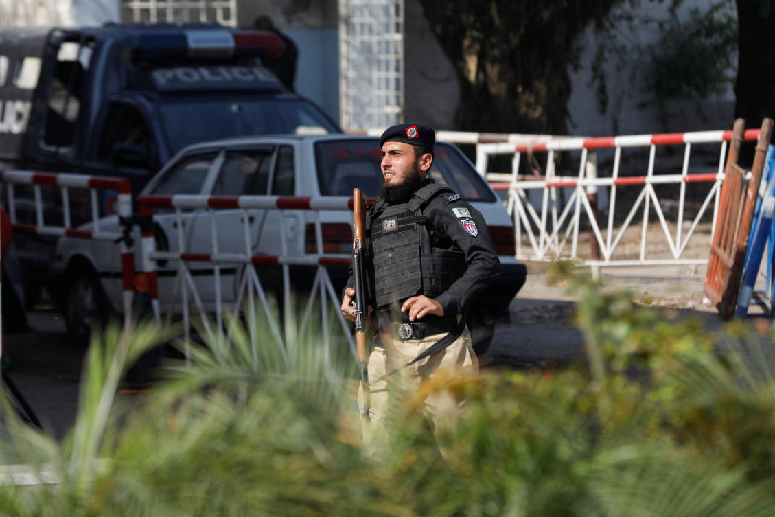 A police officer guards the route leading to the building after yesterday's attack on a police station, in Karachi, Pakistan February 18, 2023. (REUTERS)