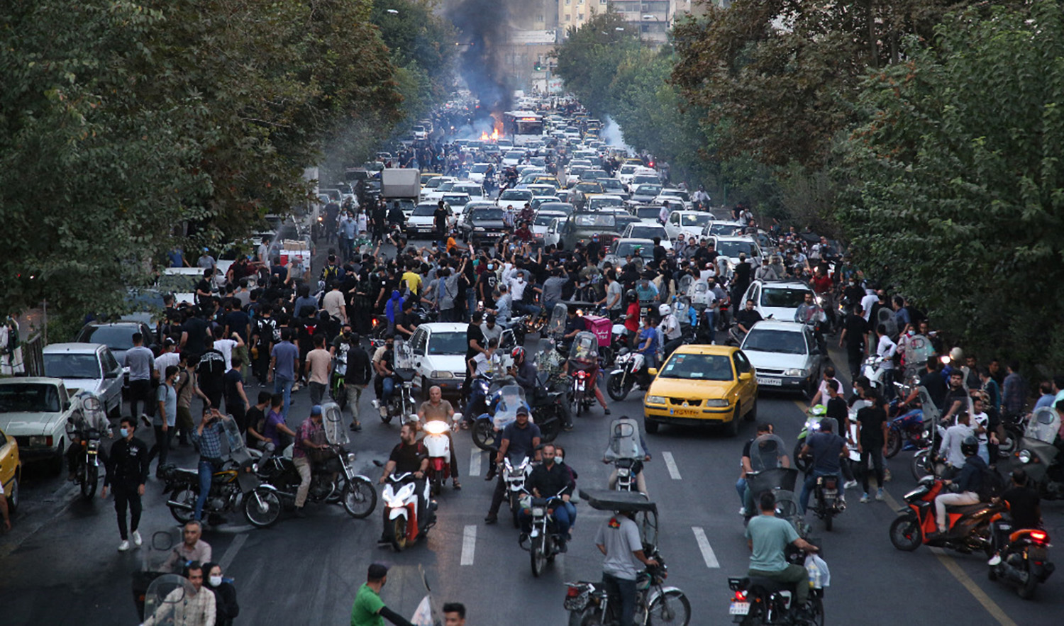 A picture obtained by AFP outside Iran on September 21, 2022, shows Iranian demonstrators taking to the streets of the capital Tehran during a protest for Mahsa Amini, days after she died in police custody. (AFP/File)