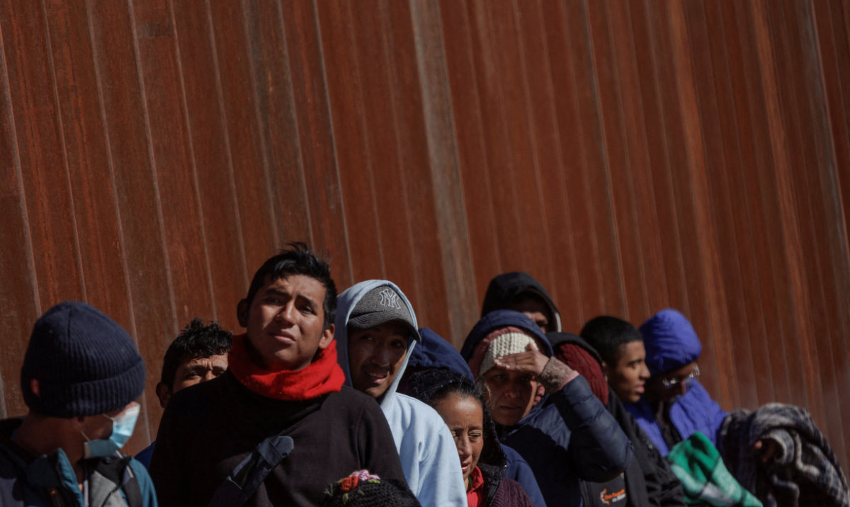 Migrants seeking asylum in the US wait in line along the border fence at the Rio Bravo river, the border between Mexico and the US, as seen from El Paso, Texas, US. (Reuters/File)