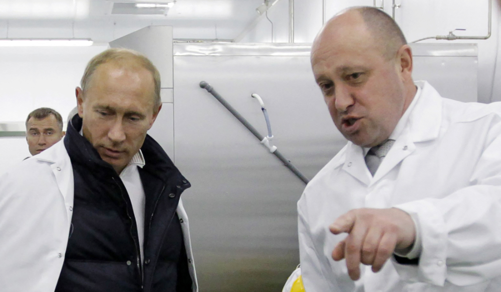 In this file photo taken on September 20, 2010 Businessman Yevgeny Prigozhin shows Russian Prime Minister Vladimir Putin his school lunch factory outside Saint Petersburg. (AFP file photo)