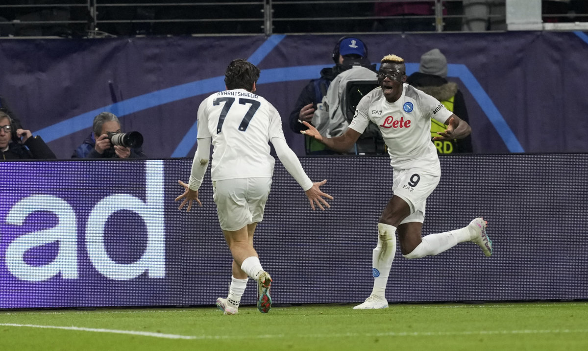 Napoli's Victor Osimhen, right, celebrates with teammate Khvicha Kvaratskhelia after scoring their side's opening goal during the Champions League round of 16 first leg against Eintracht Frankfurt at the Deutsche Bank Arena in Frankfurt Tuesday. (AP)