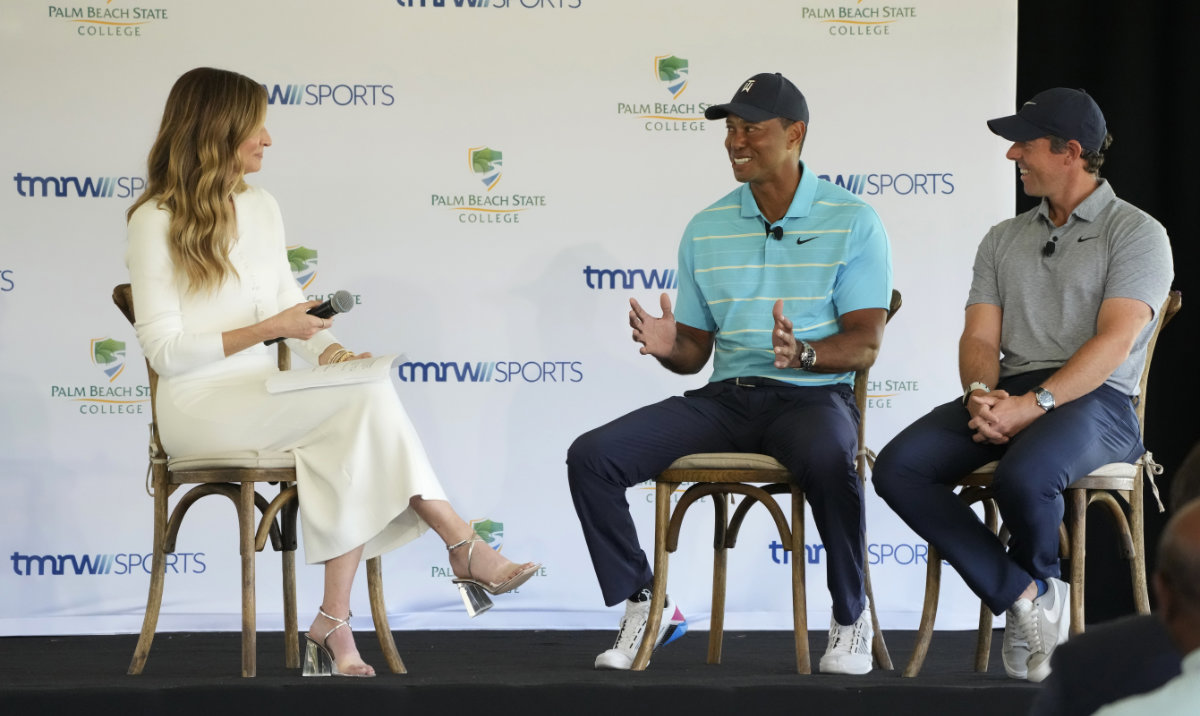 Tiger Woods, center, and Rory McIlroy, right, talk to host Erin Andrews as they discuss the future home of their tech-infused golf league that will begin play next year, Tuesday on the campus of Palm Beach State College in Palm Beach Gardens, Fla. (AP)
