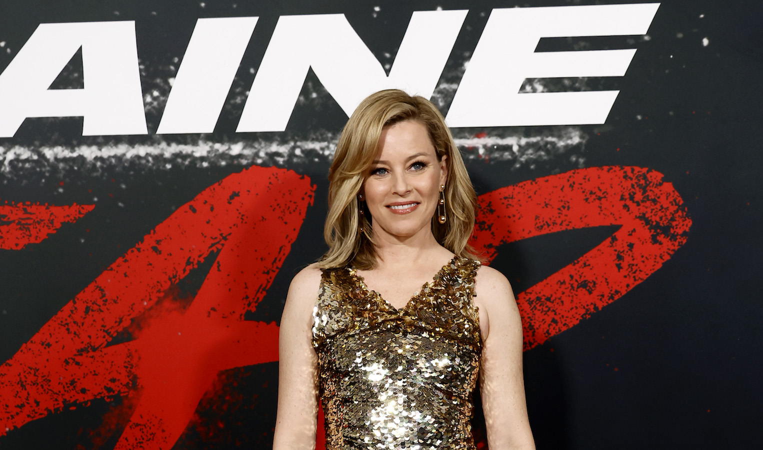 The star wore a sequin-embellished minidress with side draped panels. (Getty Images)