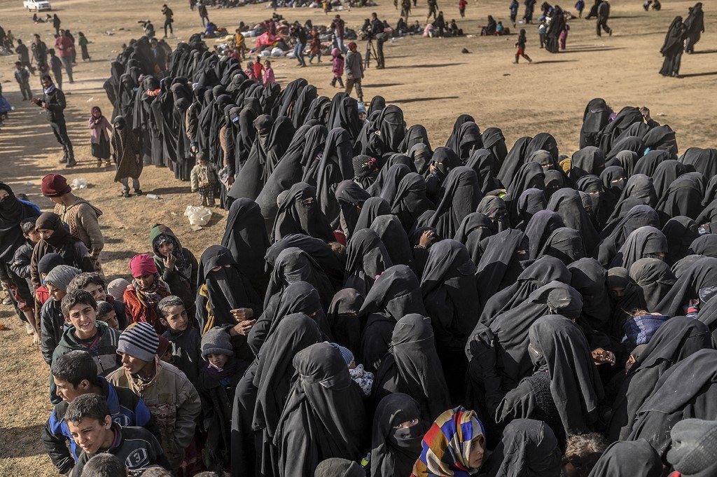 Civilians evacuated from the Daesh's embattled holdout of Baghouz wait at a screening area held by the US-backed Kurdish-led Syrian Democratic Forces