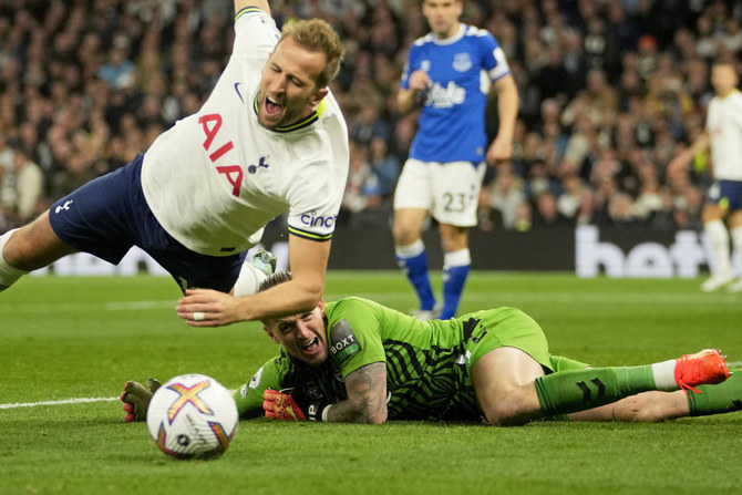 Everton’s goalkeeper Jordan Pickford dives for a save but ends up bringing down Tottenham’s Harry Kane during their Premier League match at the Tottenham Hotspur Stadium in London in October 2022. (AP)