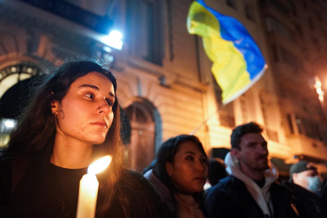 People hold a silent candlelight vigil to show their support for Ukraine on the eve of the war's anniversary, in New York City (REUTERS)