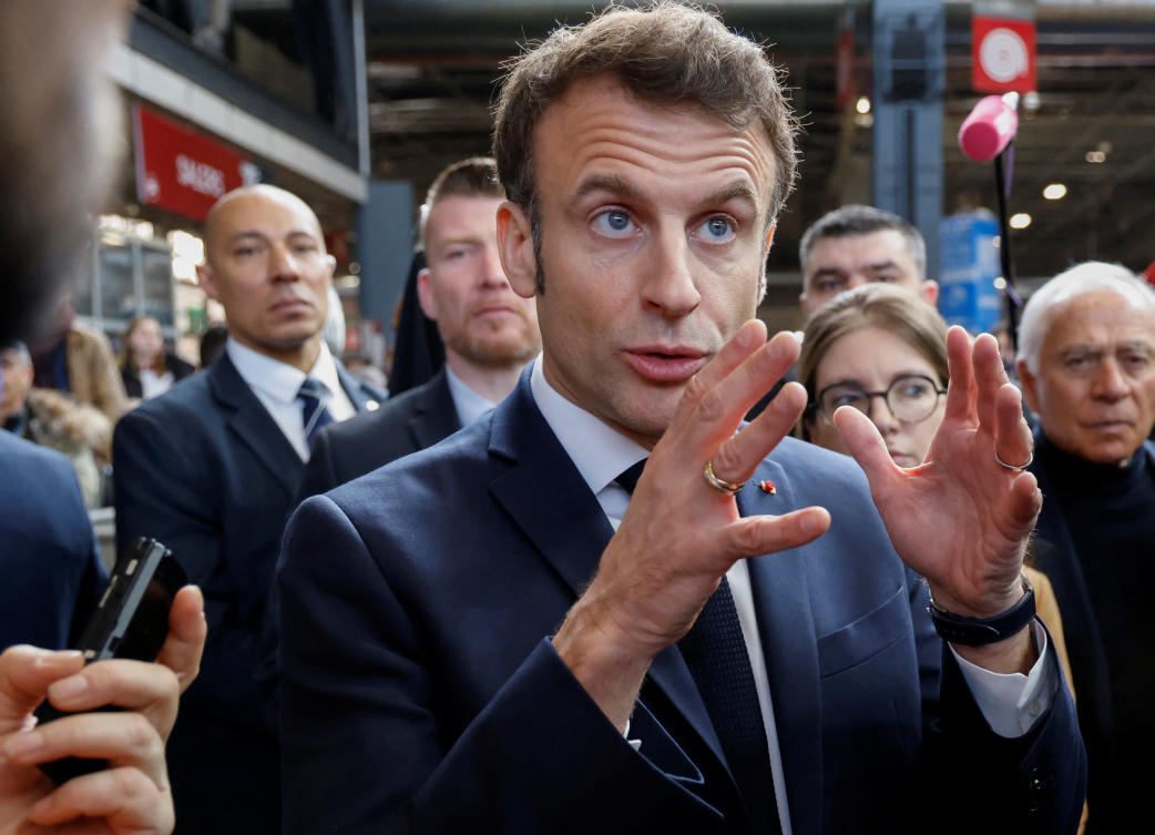 France's President Emmanuel Macron, flanked by 'Renaissance' senator Francois Patriat, gestures as he visits the 59th edition of the Agriculture fair on its inauguration day in Paris, France Feb. 25, 2023. (Reuters)