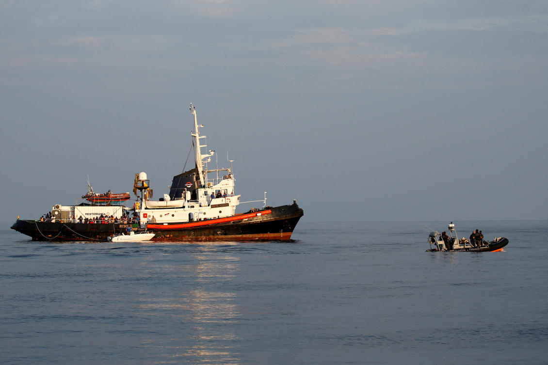 Above, an Italian police rigid-hulled inflatable boat patrols near the migrant rescue ship Mare Jonio in international waters of the Italian island of Lampedusa. (Reuters)