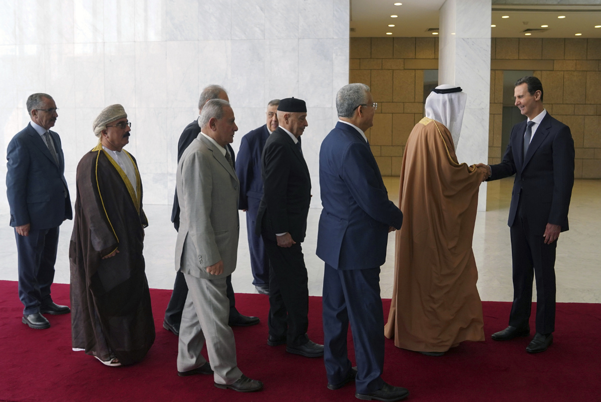 Syrian President Bashar Assad, right, receives a delegation representing various Arab parliaments in Damascus on Feb. 26, 2023. (SANA via AP)