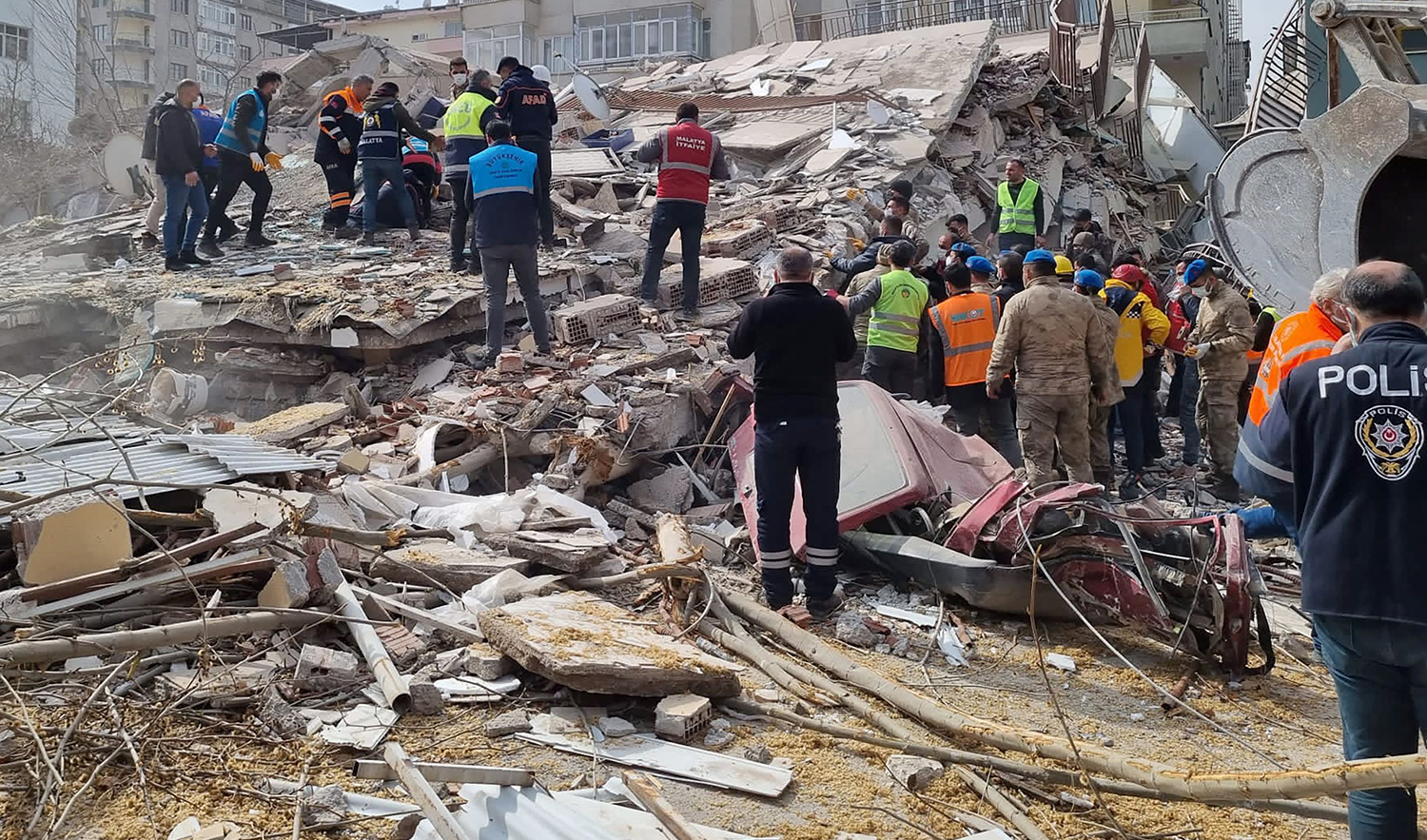 Rescuers carry on search operations among the rubble of collapsed buildings in the Yesilyurt district of Malatya on February 27, 2023 after a 5,6 magnitude earthquake hit eastern Turkey. (Demiroren News Agency via AFP)