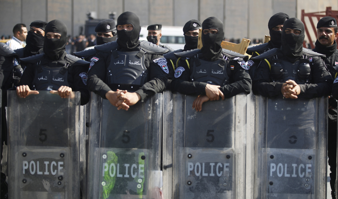 Iraqi security members during a protest near Baghdad's Green Zone on February 27, 2023 as the Iraqi Parliament convenes to amend the electoral law for governorate councils. (AFP)