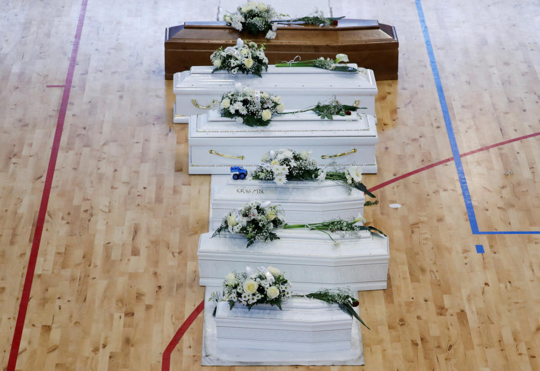 Coffins containing people who died in a migrant shipwreck, lie in state at Palasport in Crotone, Italy, February 28, 2023. (Reuters)