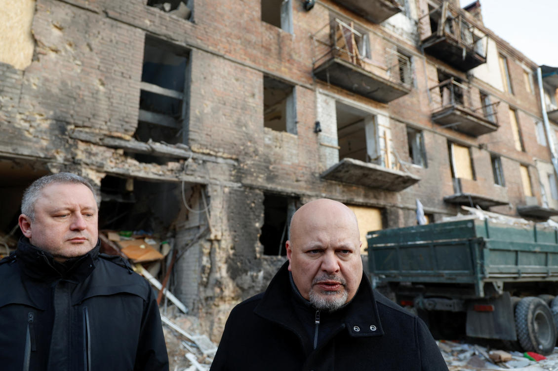 ICC Prosecutor Karim Khan and Ukrainian Prosecutor General Andriy Kostin speak to journalists as they visit the site of a residential building damaged by a Russian missile strike late November, in the town of Vyshhorod, outside Kyiv on Feb. 28, 2023. (Reuters)