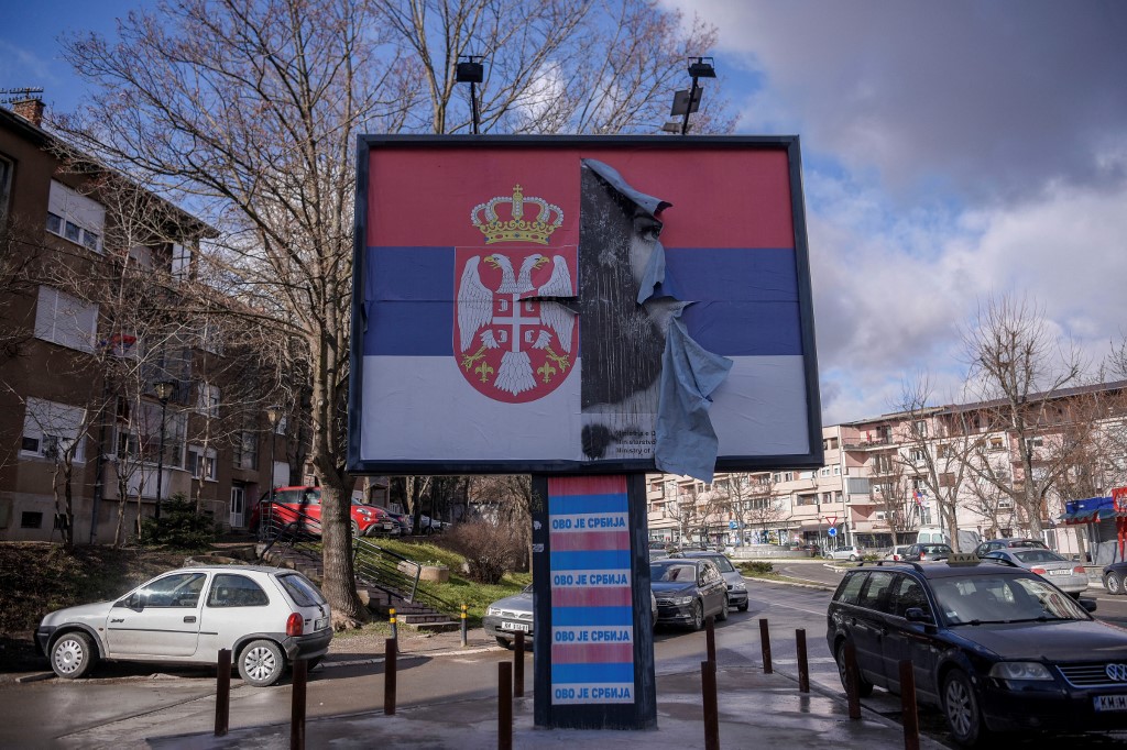 A torn poster depicting the Serbian National flag and bearing the slogan “This is Serbia” is pictured in the northern part of Mitrovica, Kosovo. (File/AFP)