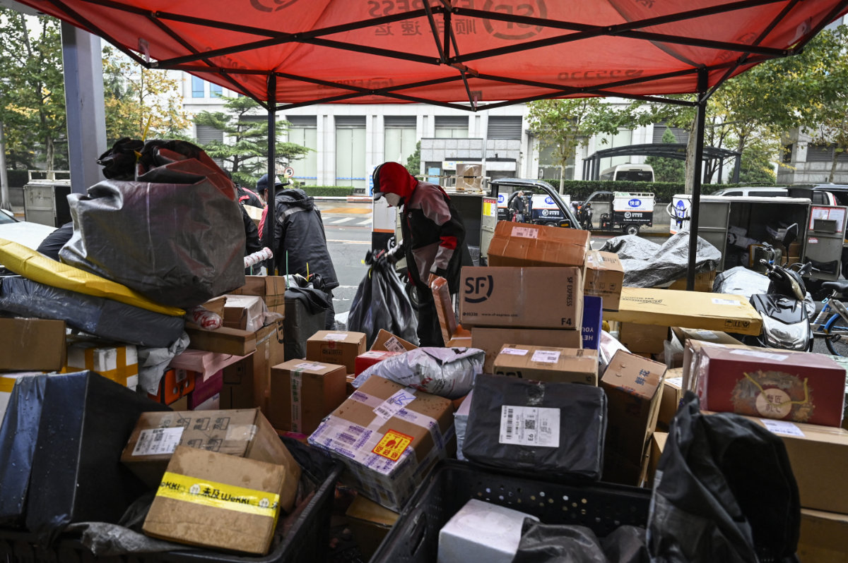 Goods shopped online are being prepared in a Beijing street for shipping to customers. (AFP)