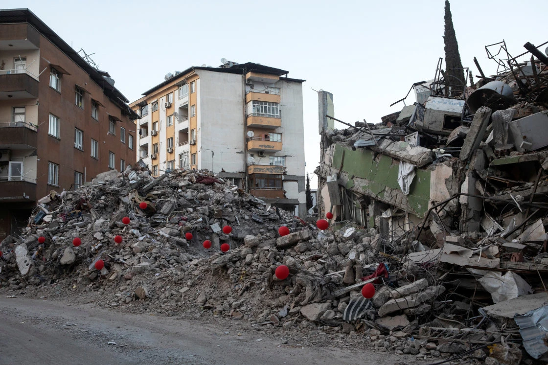 Red balloons attached to parts of a destroyed building are seen, in the aftermath of the deadly earthquake, in Turkey. (Reuters)