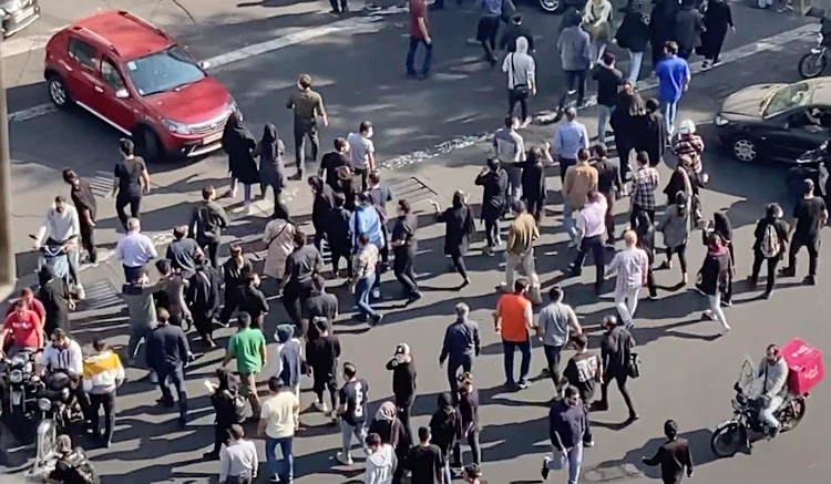 People blocking an intersection during a protest in Tehran, Iran, Oct. 26, 2022. (AP)