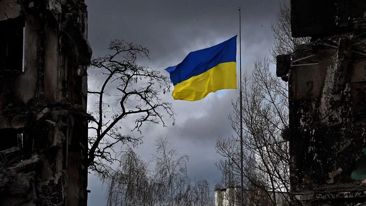 The Ukrainian flag flutters between buildings destroyed in bombardment, in the Kyiv region. (AFP)