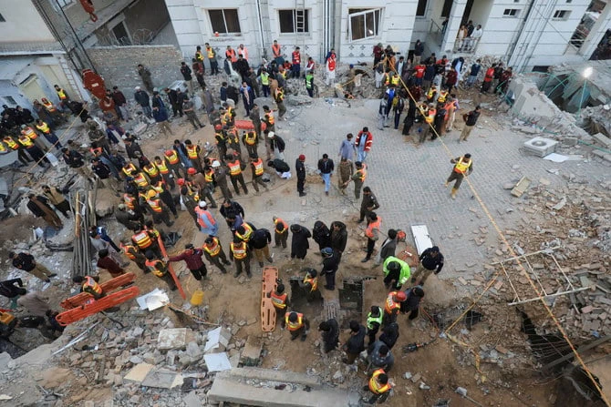 Rescue workers look for survivors under a collapsed roof, after a suicide blast in a mosque in Peshawar, Pakistan, on January 30, 2023. (Reuters)