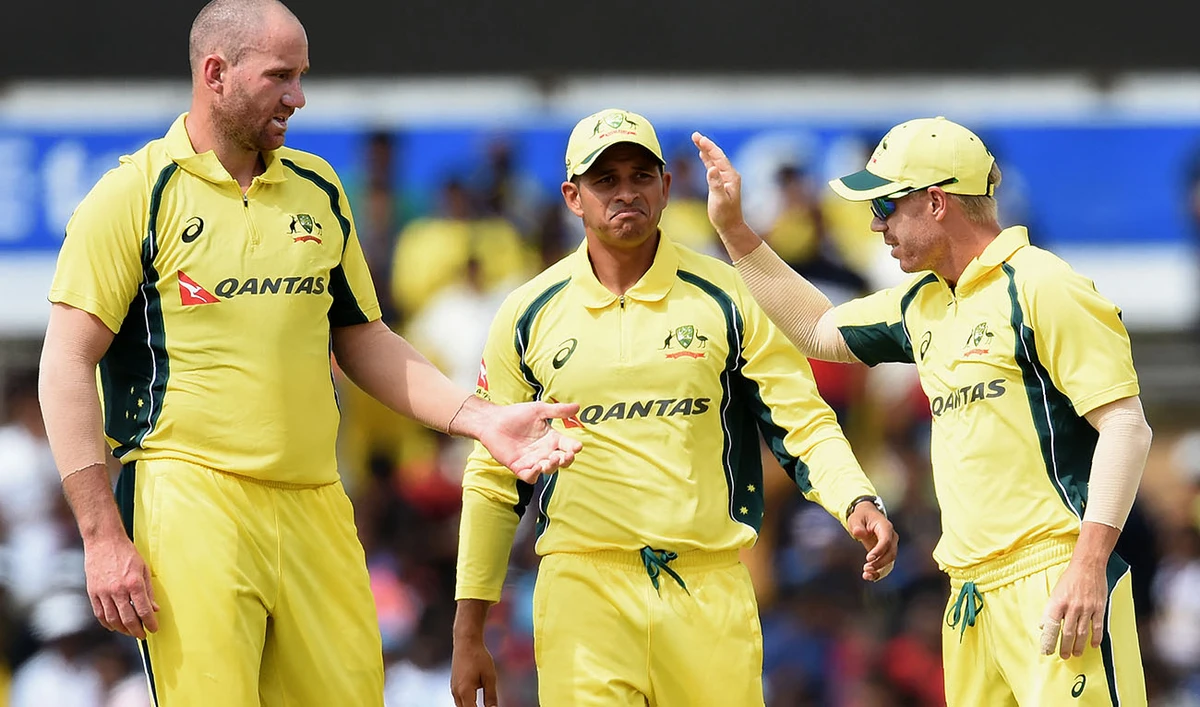 Australian cricketer John Hastings (L) celebrates with teammates Usman Khwaja(C) and David Warner(R) after he dismissed unseen Sri Lanka batsman Kusal Mendis during the fourth one day international (ODI) cricket match between Sri Lanka and Australia at The Rangiri Dambulla International Cricket Stadium in Dambulla on August 31, 2016. (AFP)