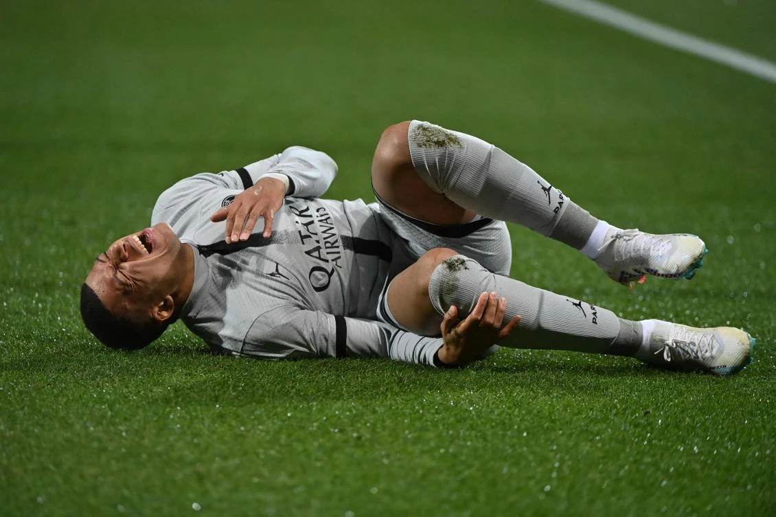 PSG’s French forward Kylian Mbappe lies on the ground after getting injured during their French L1 match against Montpellier Herault SC at Stade de la Mosson in Montpellier on February 1, 2023. (AFP)