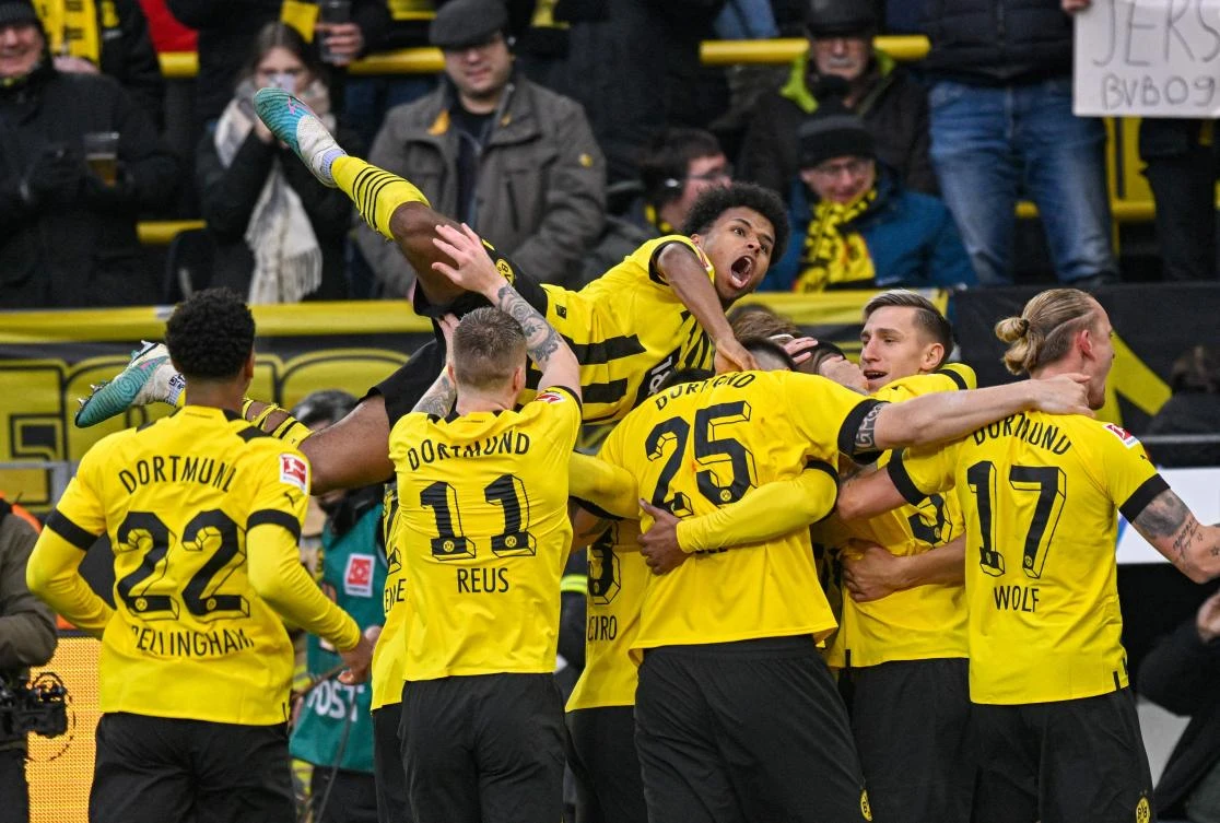 Dortmund’s Karim Adeyemi reacts as Sebastien Haller celebrates scoring the 3-1 goal with teammates during their Bundesliga match against SC Freiburg in Dortmund on February 4, 2023. (AFP)